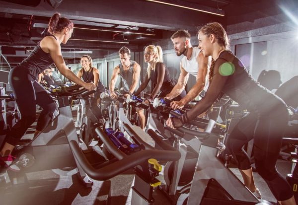 Fit people working out at exercising class in the gym.